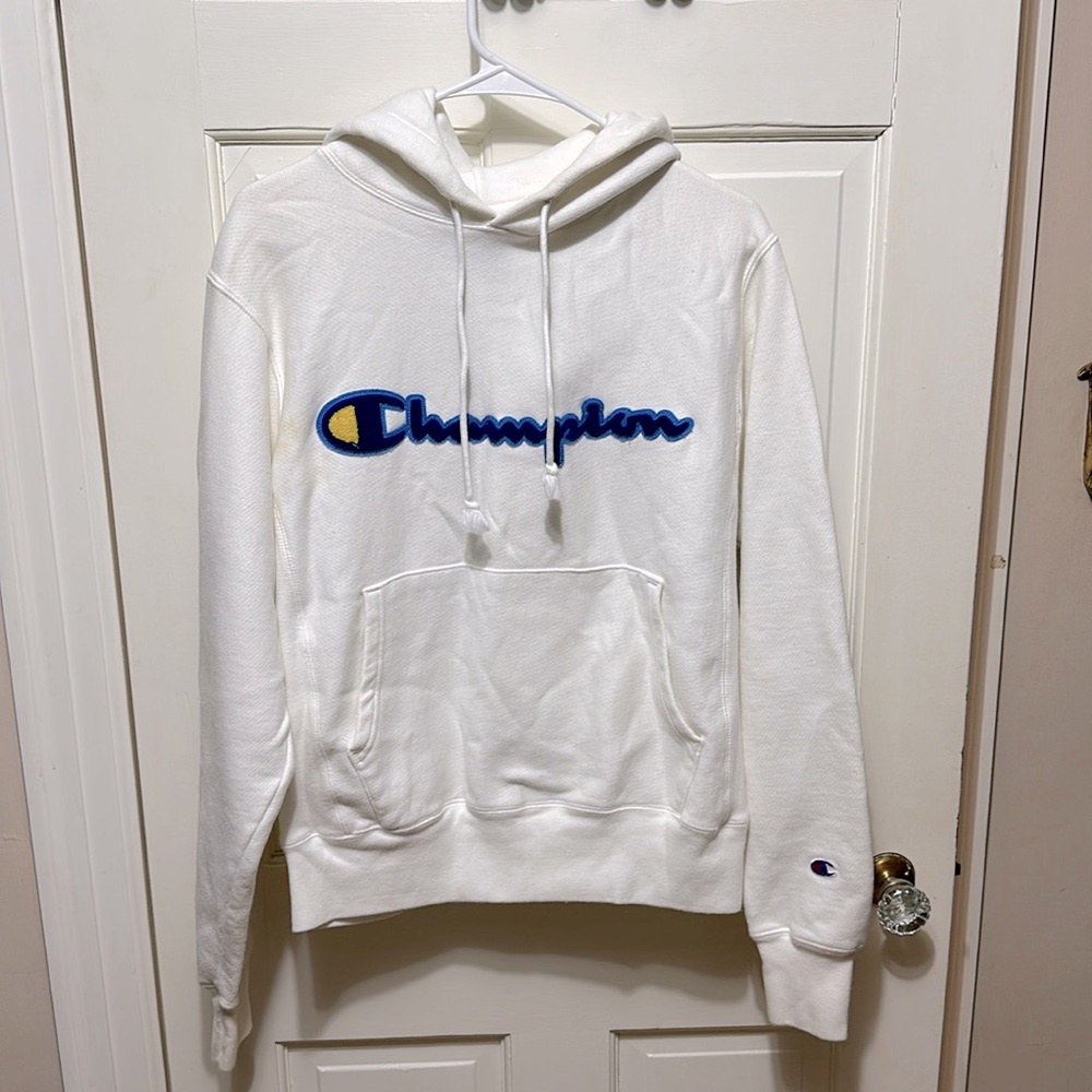 White reverse weave champion hoodie with blue and yellow lettering